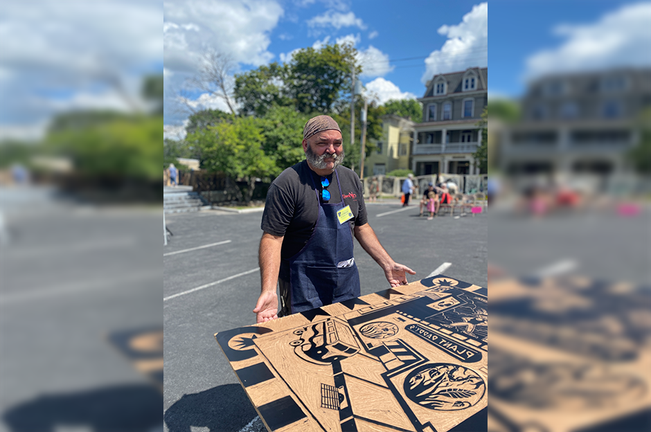 man holding steam rolling carving