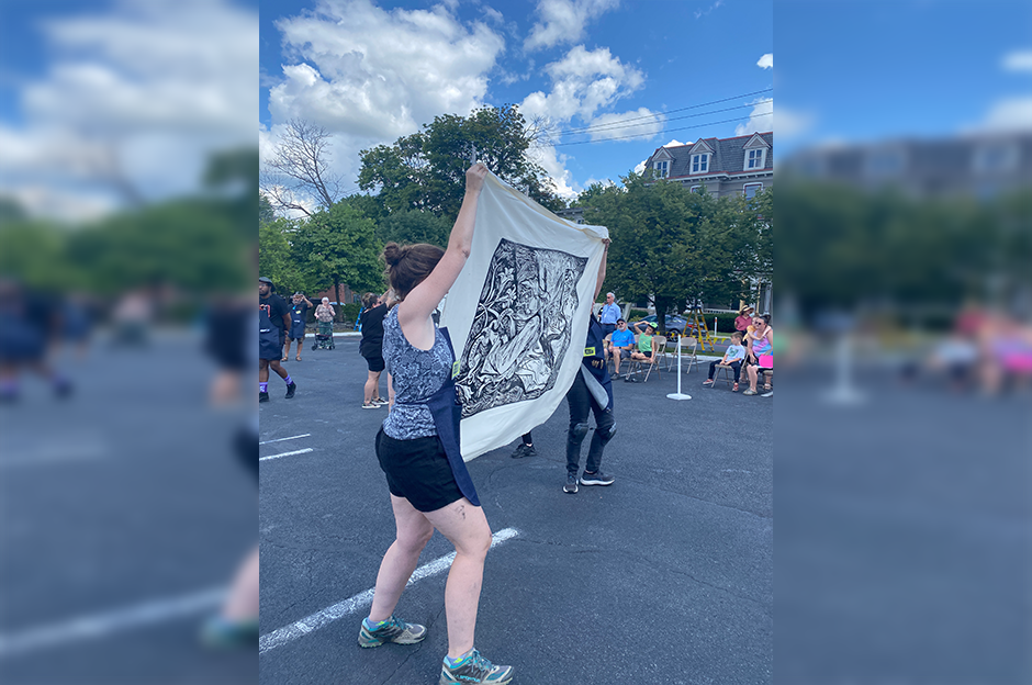 people holding finished steam rolling print