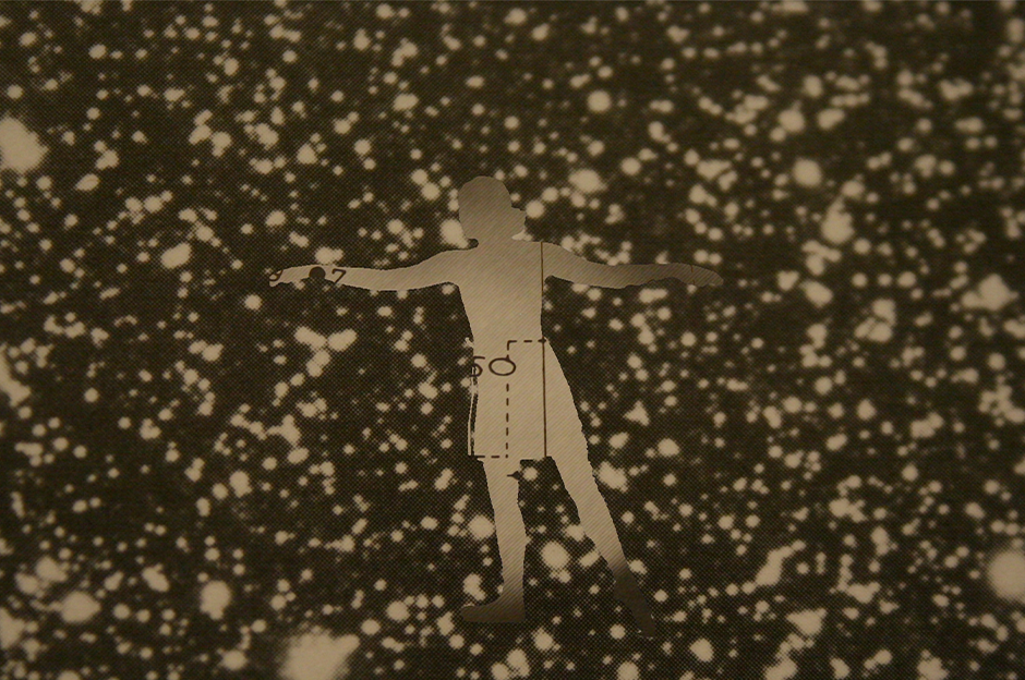 silhouette of person cutout of paper on speckled ground