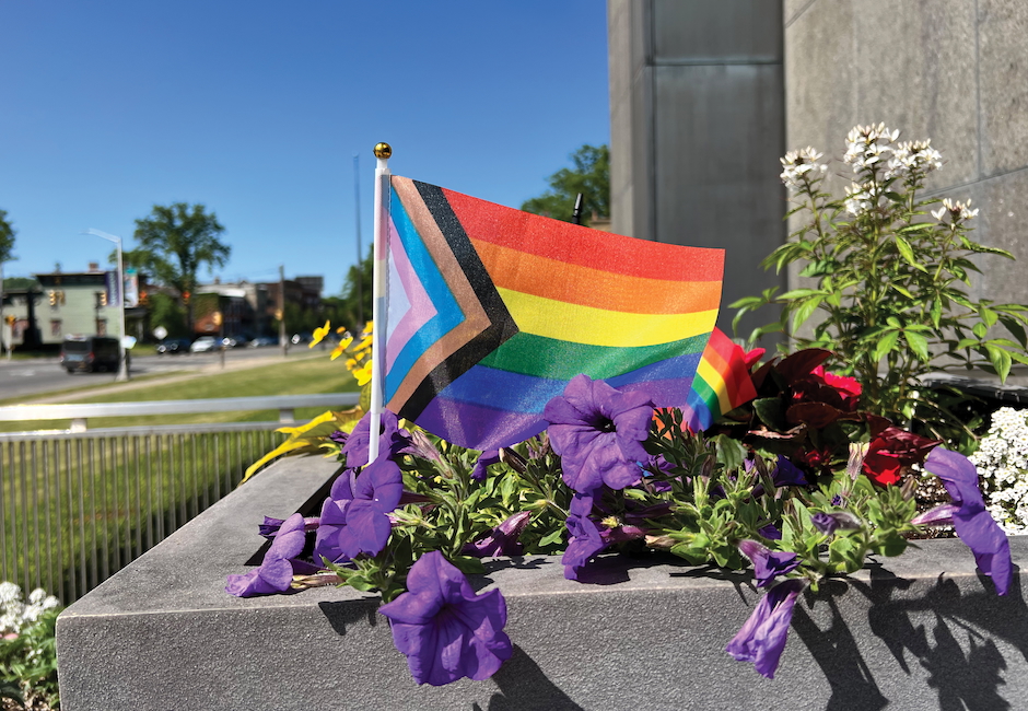 pride flag in munson flower planter out front of museum 