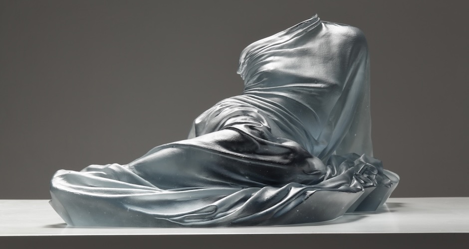 Form of woman standing, just glass dress providing form