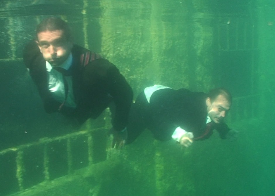 artwork by igor vamos men in suits underwater in pool