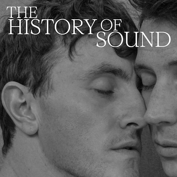 black and white image of two men with their faces against each other