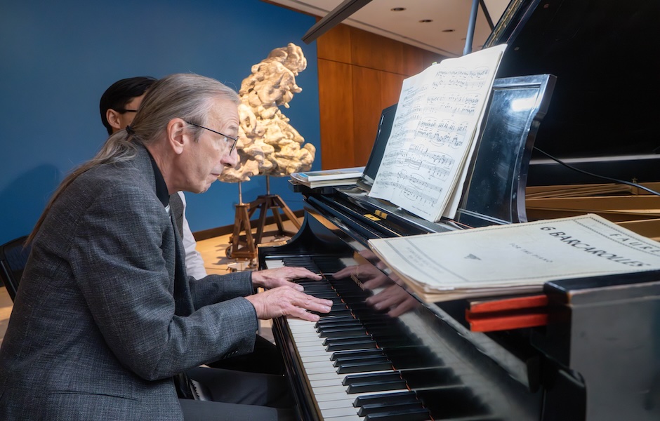 man playing piano in art gallery 