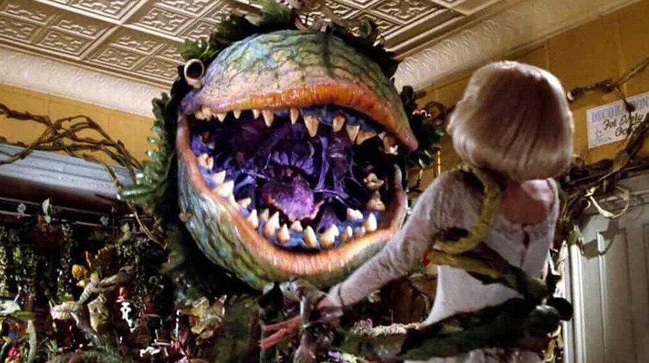 Woman being held up by monster plant