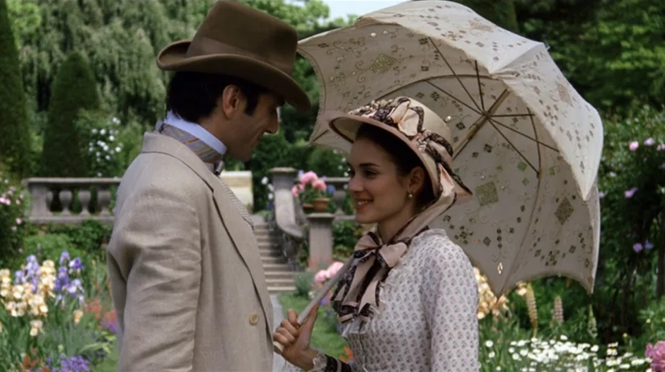 Victorian people standing in a garden with an umbrella
