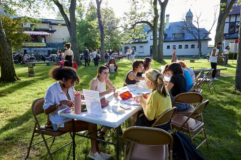 students crafting at tables outside in the garden