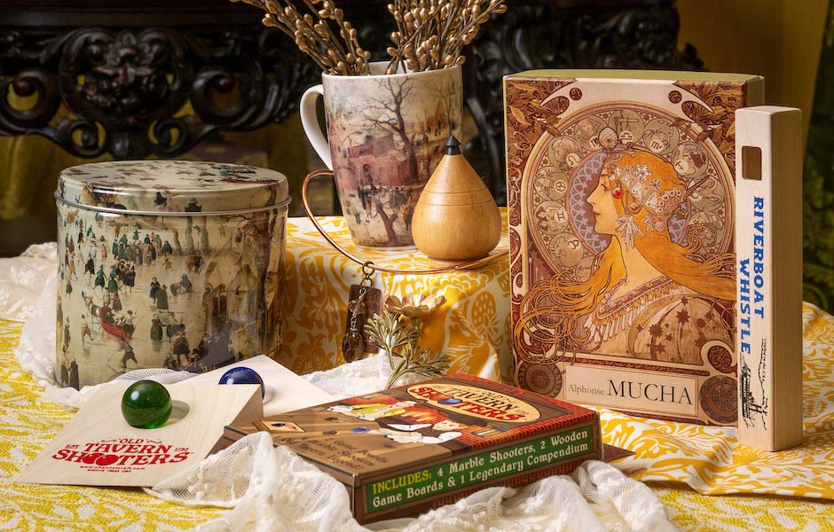 victorian patteren toys, puzzles, games, jewelry and cup on yellow fabric