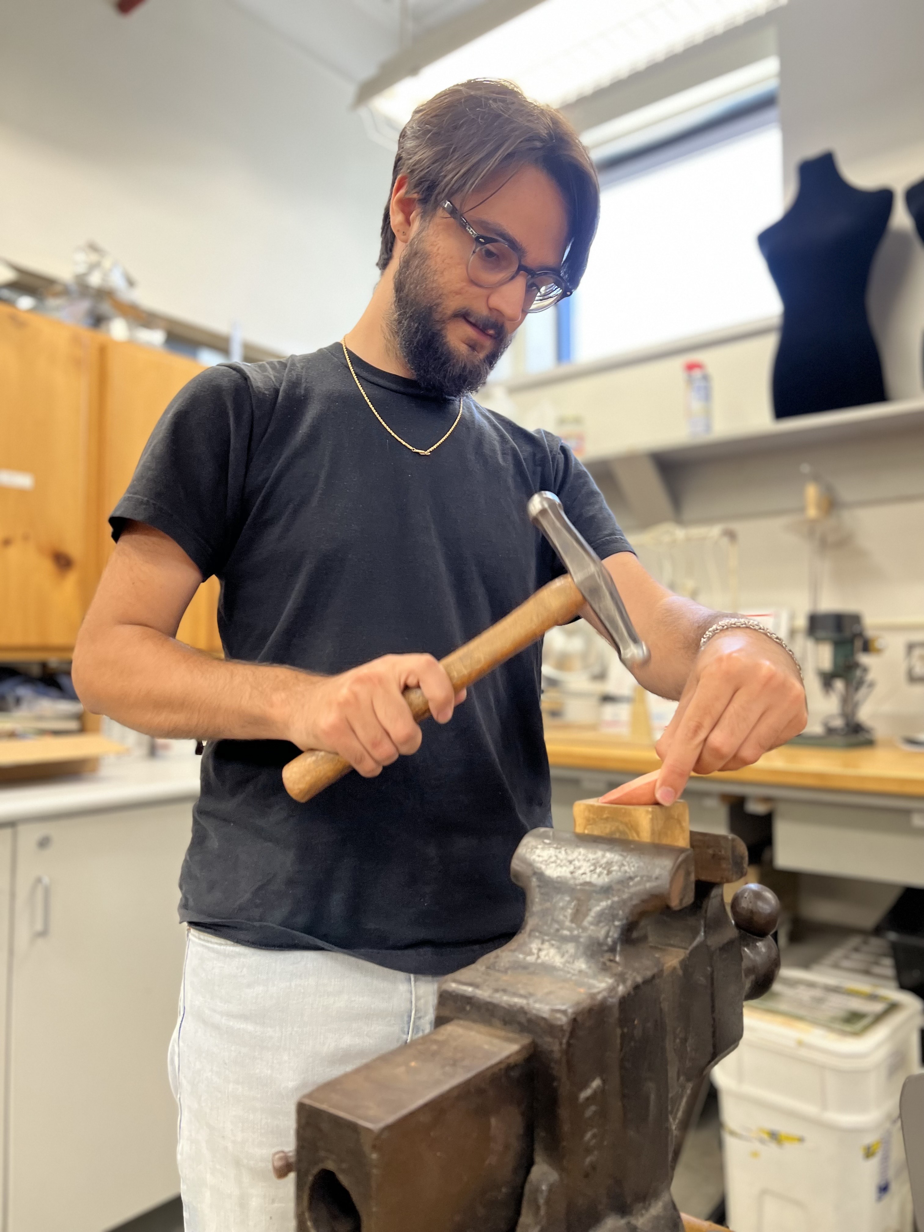 Instructor Luke Towne hammering copper