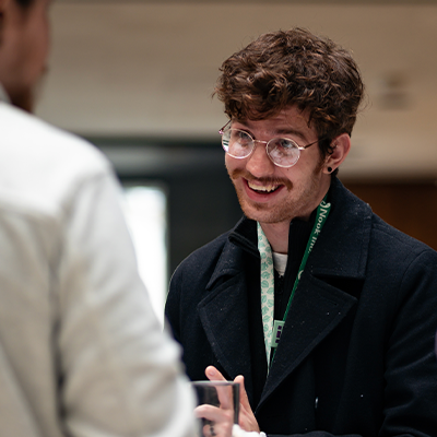 person with inviting smiling chatting with employee