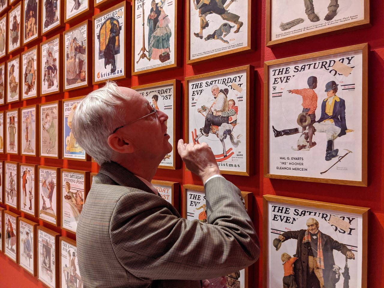 man looking at prints at norman rockwell exhibit at mwpai