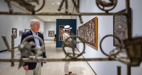 People looking at art work in Munson's permanent collection