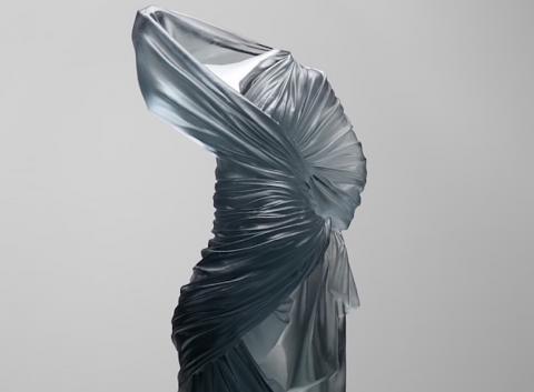 Form of woman standing, just glass dress providing form